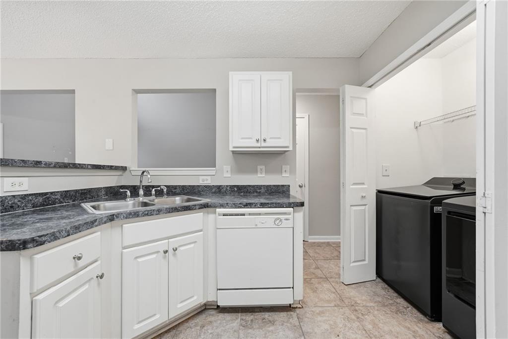 2297 Charleston Pointe Southeast Atlanta, GA 30316 - Photo 5 of 48 a kitchen with granite countertop cabinets stainless steel appliances and a sink