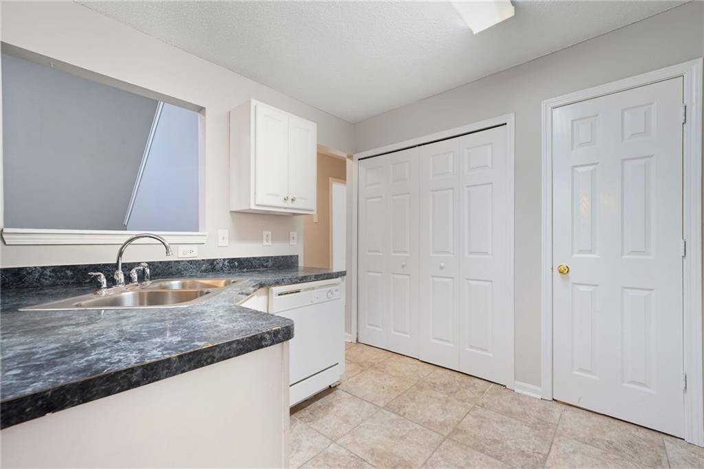 2297 Charleston Pointe Southeast Atlanta, GA 30316 - Photo 6 of 48 a kitchen with granite countertop a sink and a granite counter tops