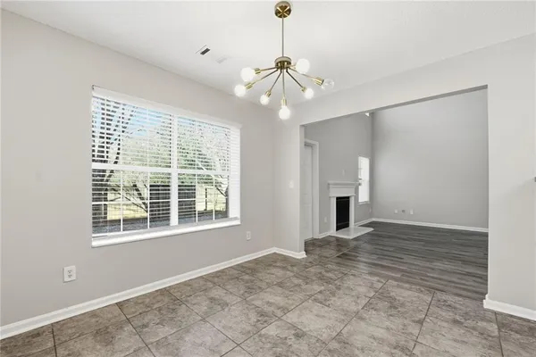 a view of an empty room with a window and fireplace