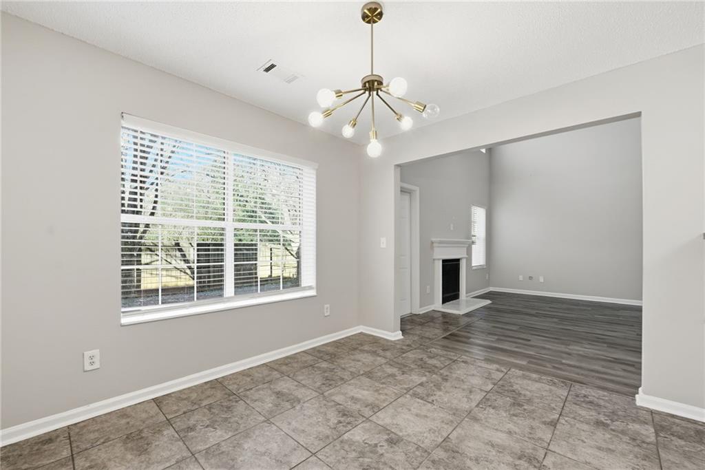 2297 Charleston Pointe Southeast Atlanta, GA 30316 - Photo 8 of 48 a view of an empty room with a window and fireplace