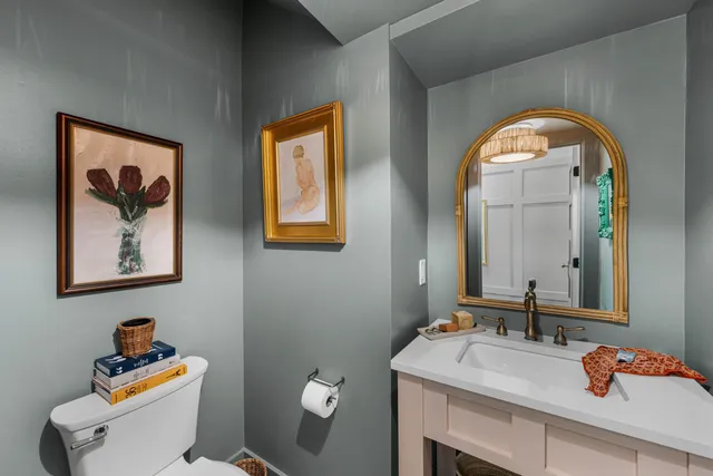 a bathroom with a toilet sink and mirror