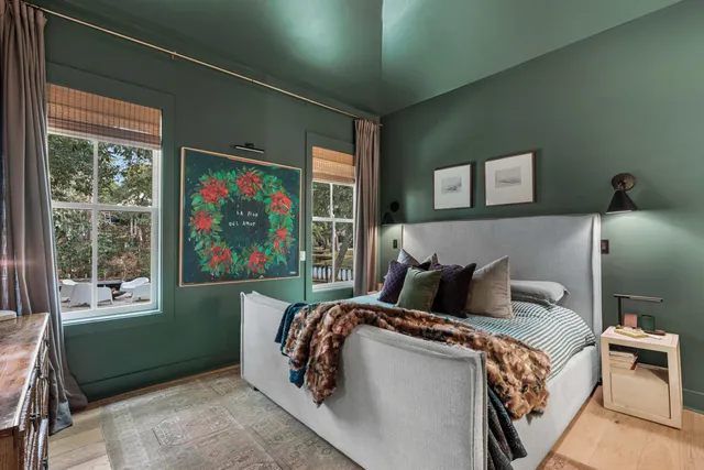 a bedroom with a large bed and a window