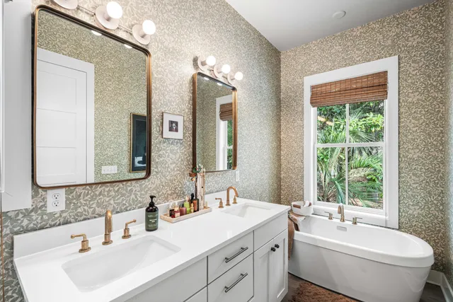 a bathroom with a double vanity sink toilet and mirror