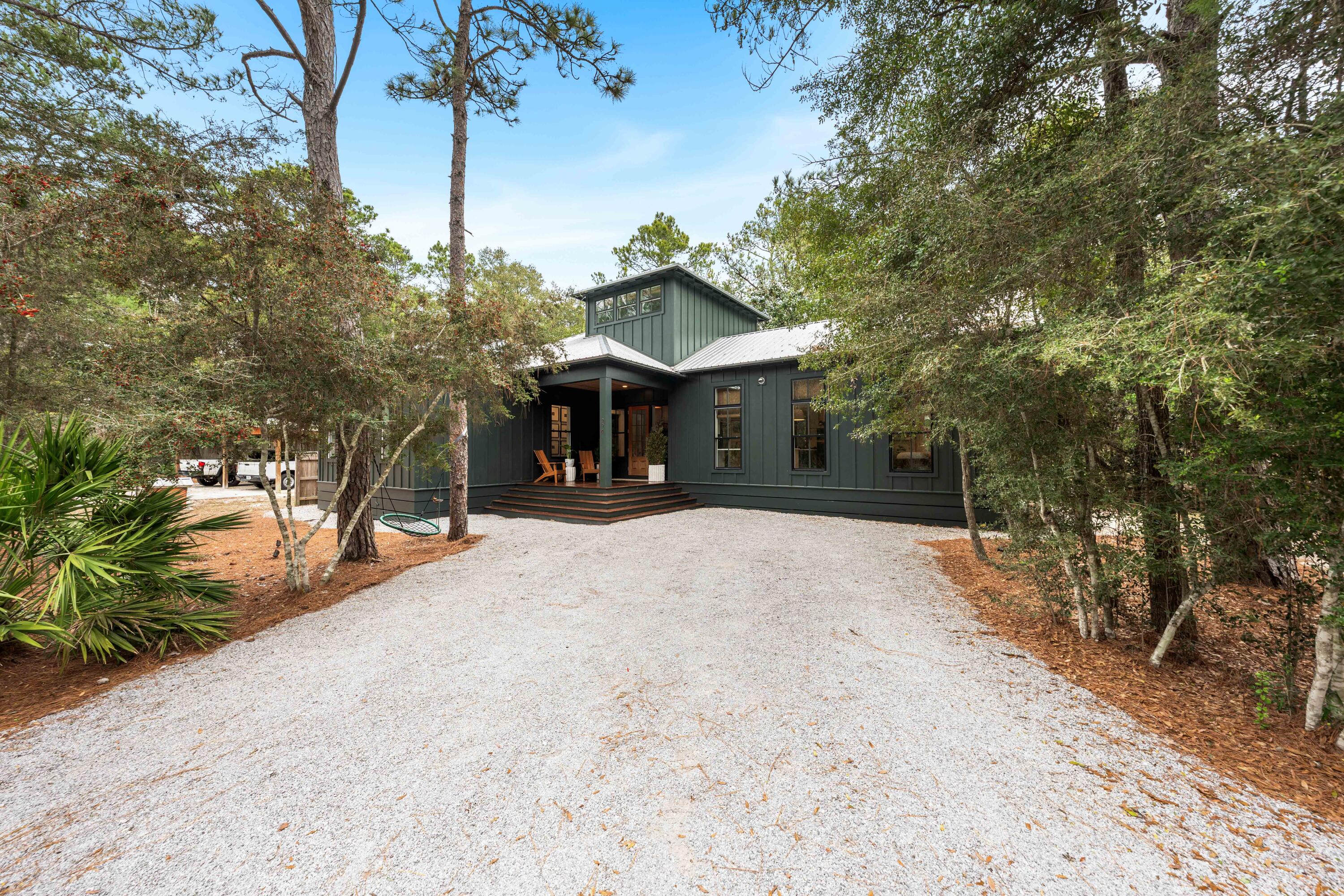 294 West Point Washington Road Santa Rosa Beach, FL 32459 - Photo 36 of 46 a front view of a house with a yard and garage