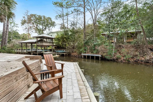a view of a lake with chairs
