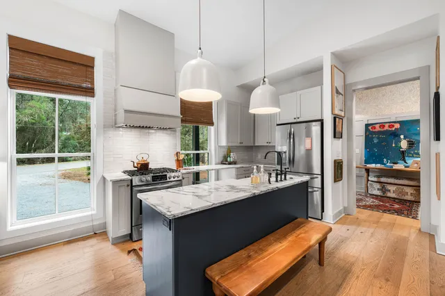 a kitchen with a stove a refrigerator and a sink