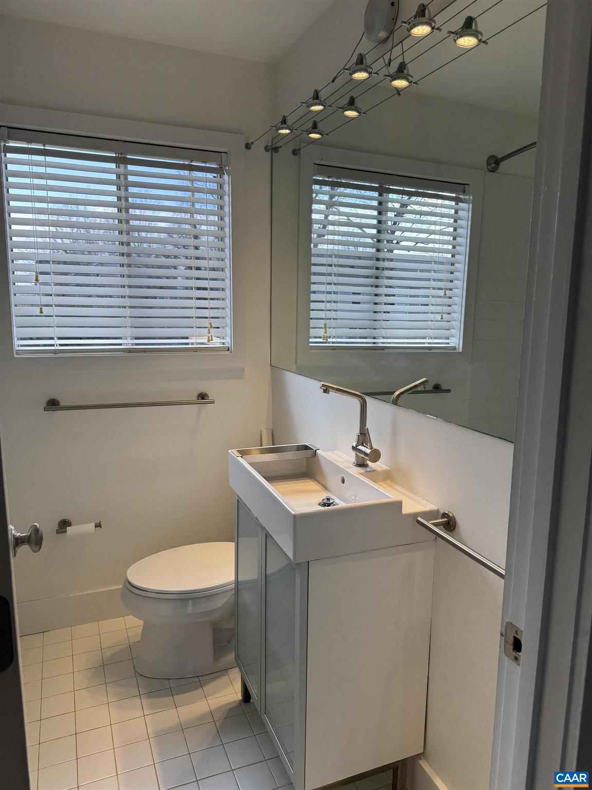 402 Harris Road Charlottesville, VA 22903 - Photo 7 of 10 a bathroom with a sink a toilet and a window