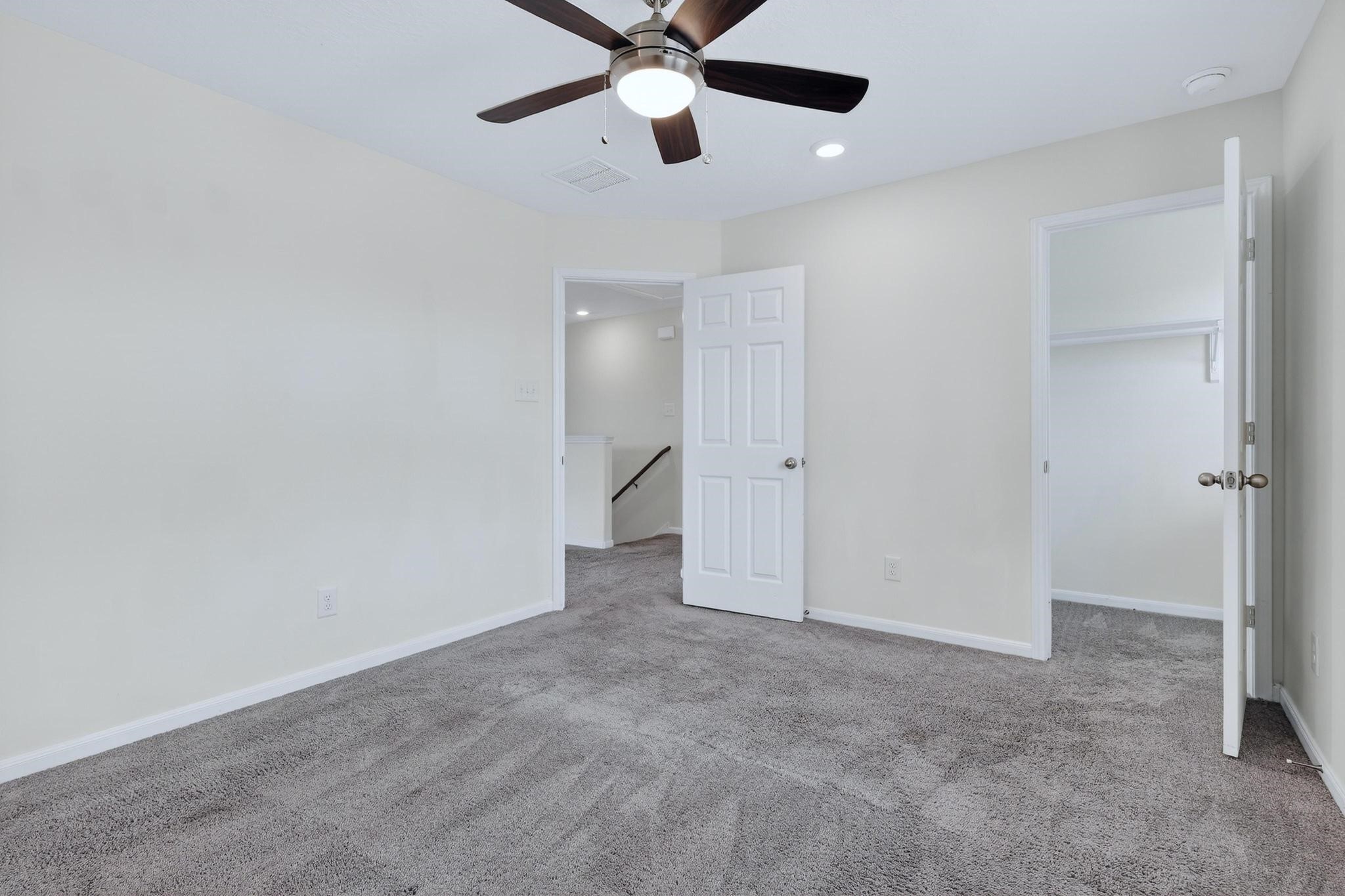 3322 Nila Creek Dr Spring Spring, TX 77373 - Photo 24 of 36 Secondary bedroom with ceiling fan, closet space, and easy access to the hallway and nearby rooms.