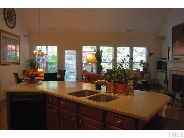 3733 Old Post Road Raleigh, NC 27612 - Photo 8 of 25 w/Corian counter tops & center island w/dual deep side sink w/arch spigot, garbage disposal, GE Profile Triton dishwasher, GE gas Profile range, built-in Samsung microwave, under cabinet lighting & extensive white custom crown molding! Kitchen