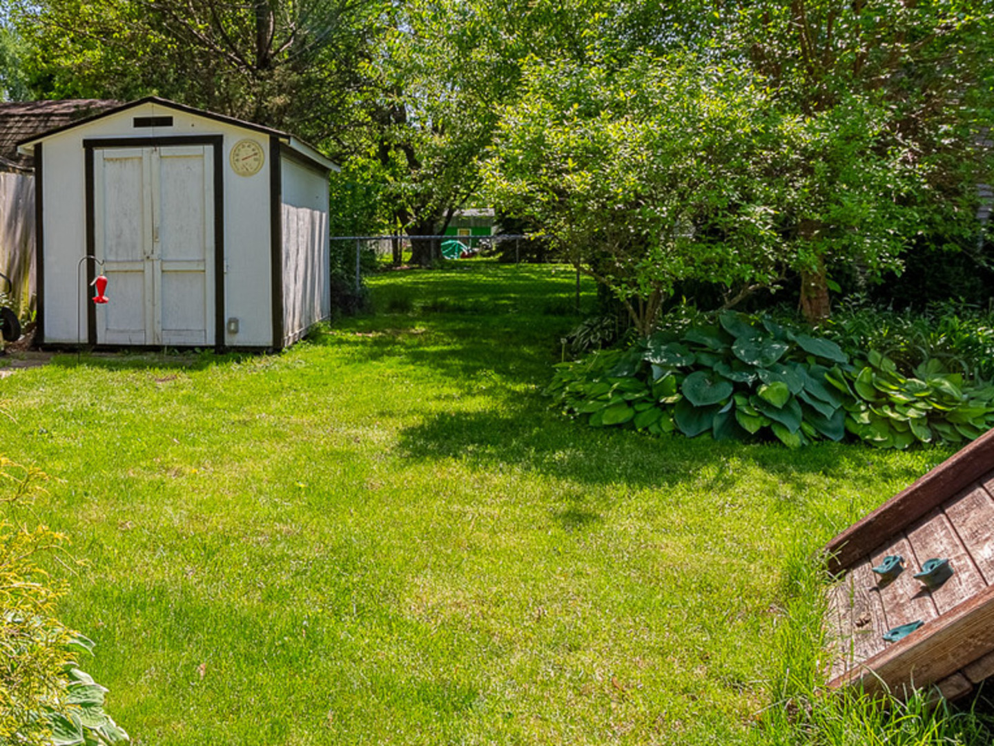 33 Ingleshire Road Montgomery, IL 60538 - Photo 18 of 22 a view of a backyard with potted plants and large trees