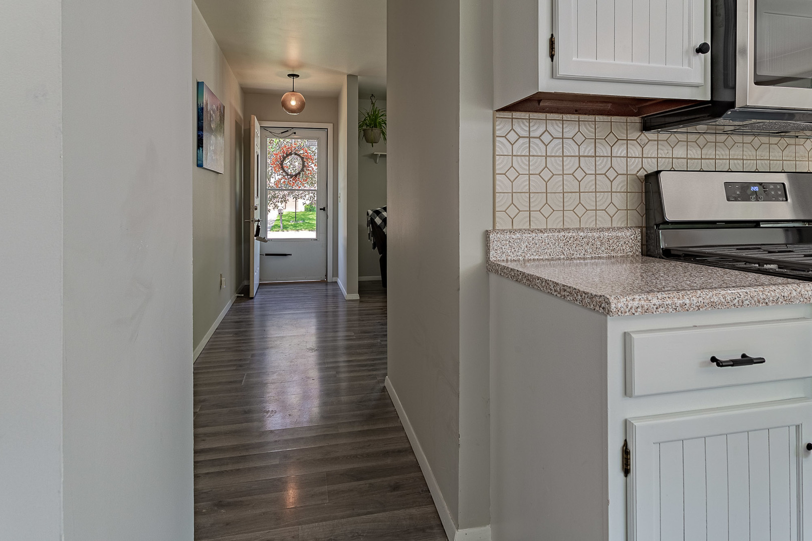 33 Ingleshire Road Montgomery, IL 60538 - Photo 21 of 22 a kitchen with granite countertop white cabinets and stainless steel appliances