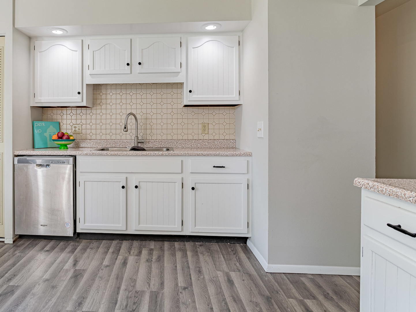 33 Ingleshire Road Montgomery, IL 60538 - Photo 6 of 22 a kitchen with granite countertop white cabinets and white appliances