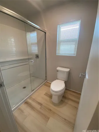 a bathroom with a toilet and a shower