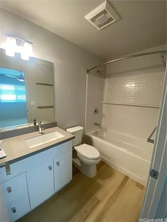 a bathroom with a double vanity sink toilet mirror and bathtub