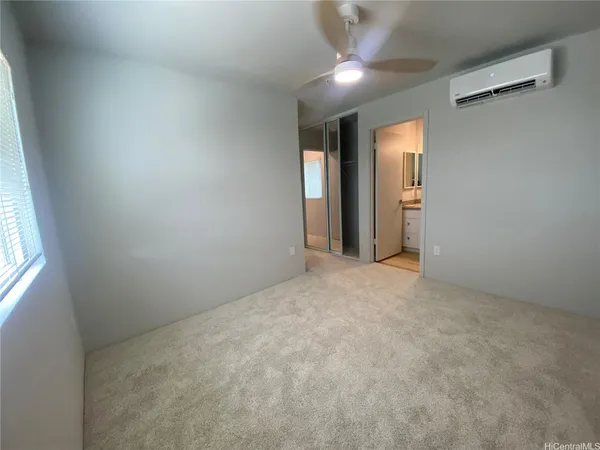 an empty room with windows and closet