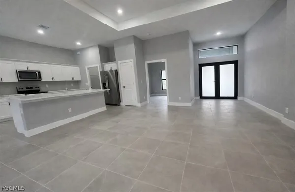 a view of a kitchen with a sink and a stove top oven