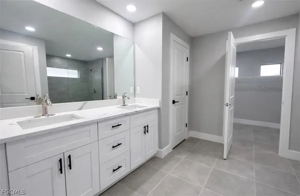 a spacious bathroom with a double vanity sink mirror and double