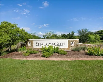 a front view of a building with a garden and plants