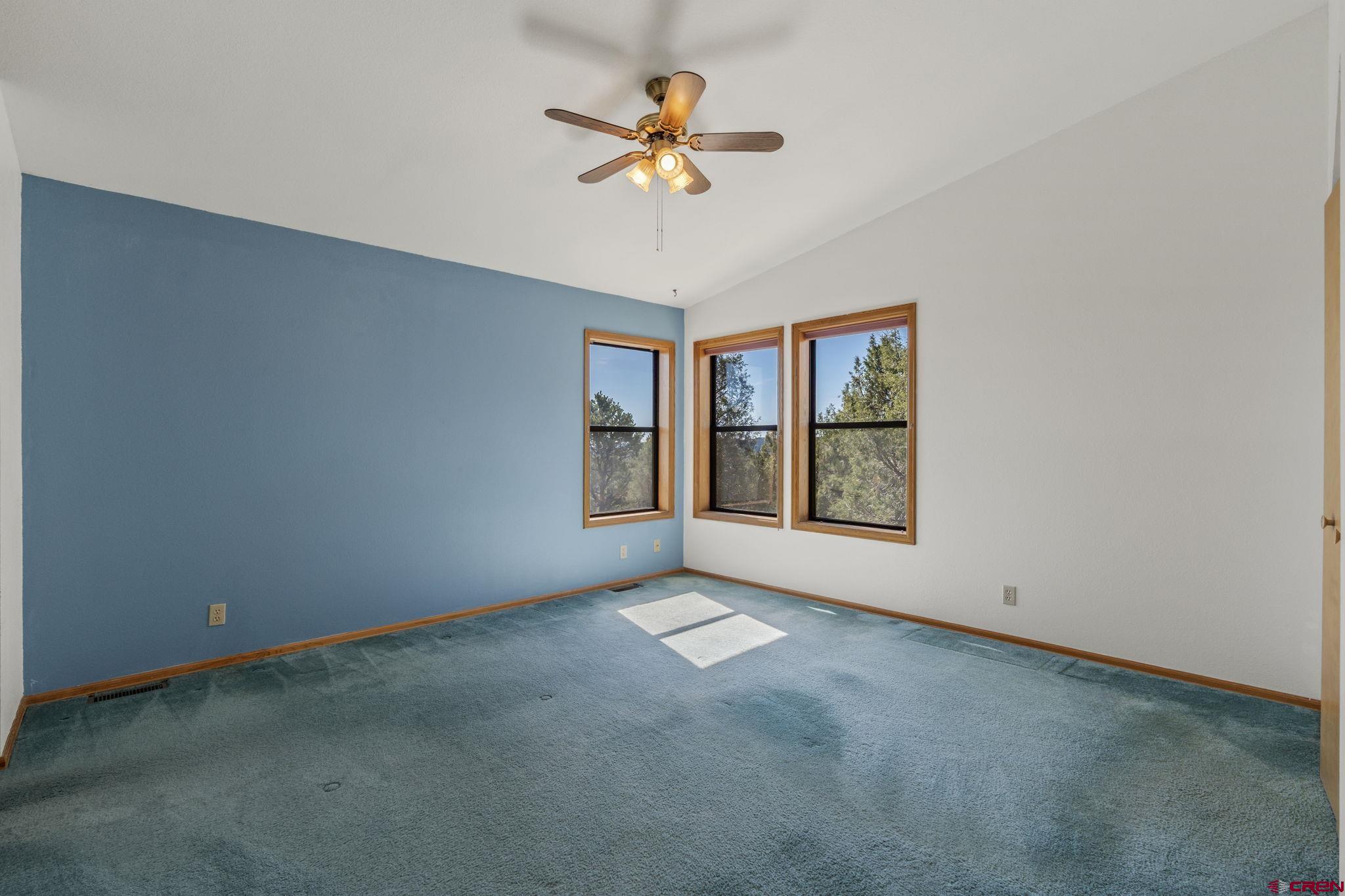 720 Sawmill Road Durango, CO 81303 - Photo 18 of 41 a view of an empty room with window and chandelier fan