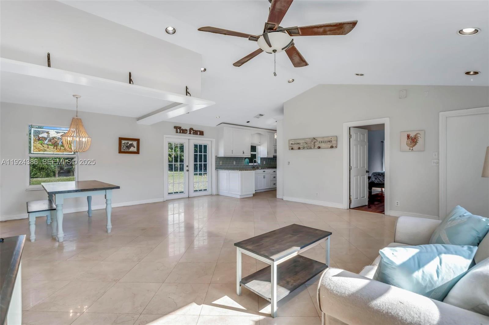 17607 88th Road North Loxahatchee, FL 33470 - Photo 13 of 56 a living room with furniture and kitchen view