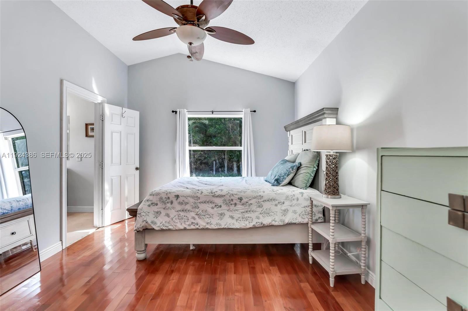 17607 88th Road North Loxahatchee, FL 33470 - Photo 20 of 56 a bedroom with a bed and a wooden floor