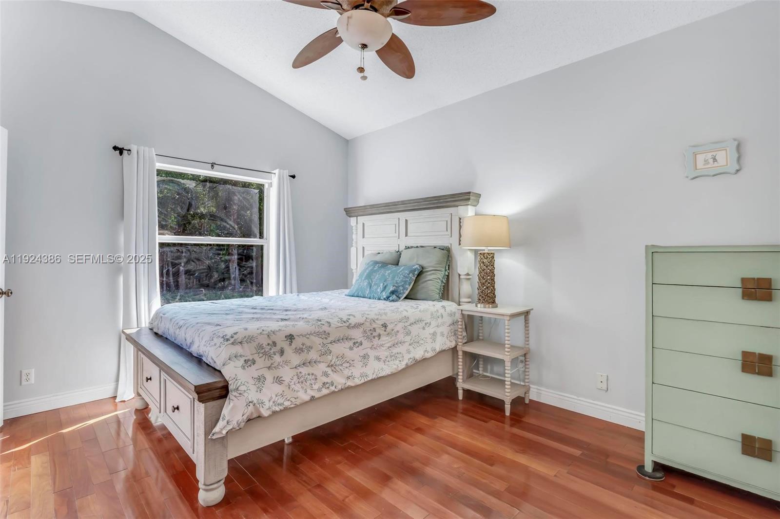 17607 88th Road North Loxahatchee, FL 33470 - Photo 21 of 56 a bedroom with a bed and a dresser