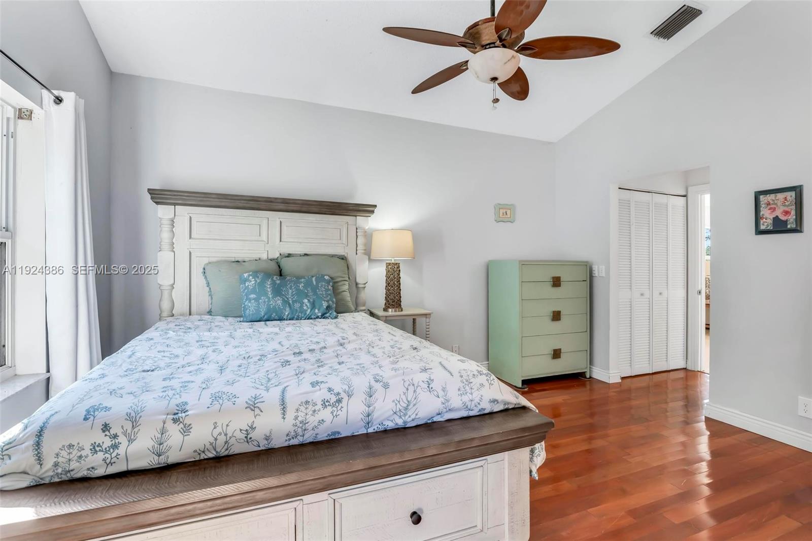 17607 88th Road North Loxahatchee, FL 33470 - Photo 22 of 56 a bedroom with a bed and wooden floor