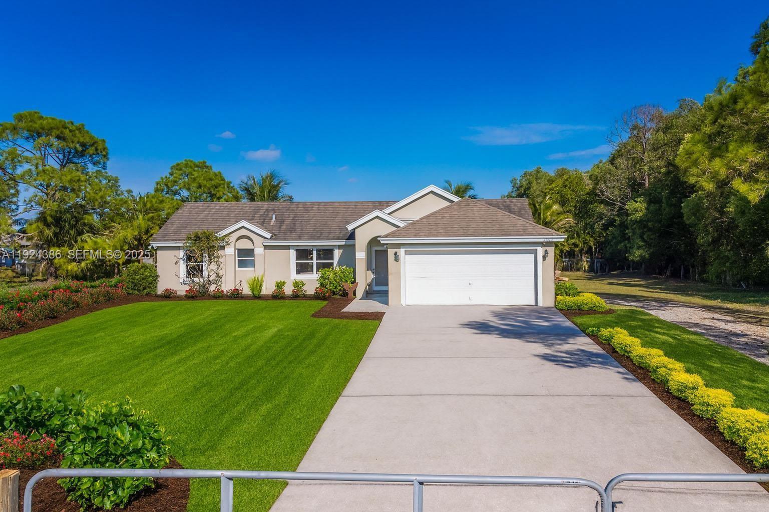 17607 88th Road North Loxahatchee, FL 33470 - Photo 3 of 56 a front view of a house with yard