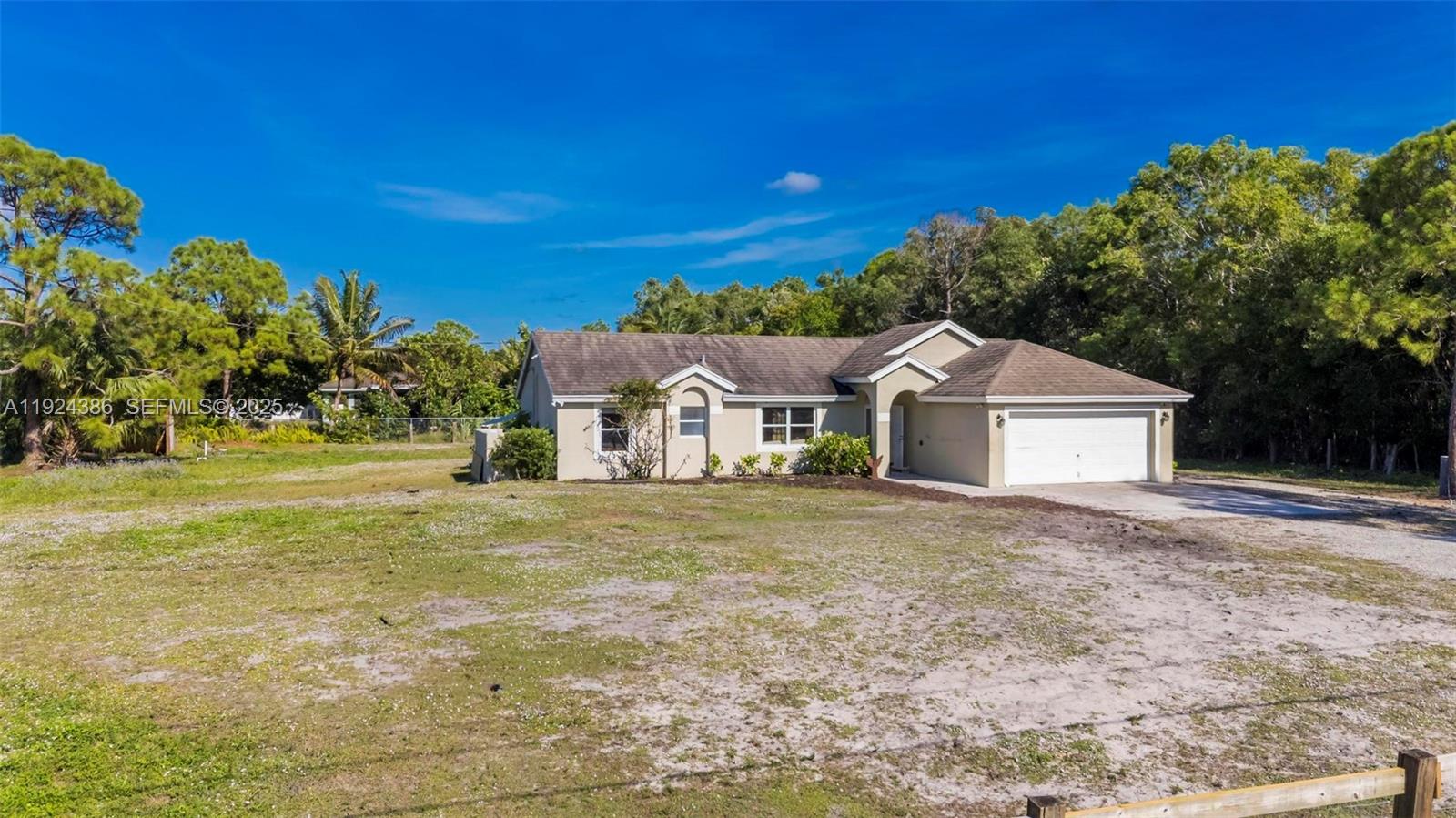 17607 88th Road North Loxahatchee, FL 33470 - Photo 32 of 56 a front view of a house with a yard