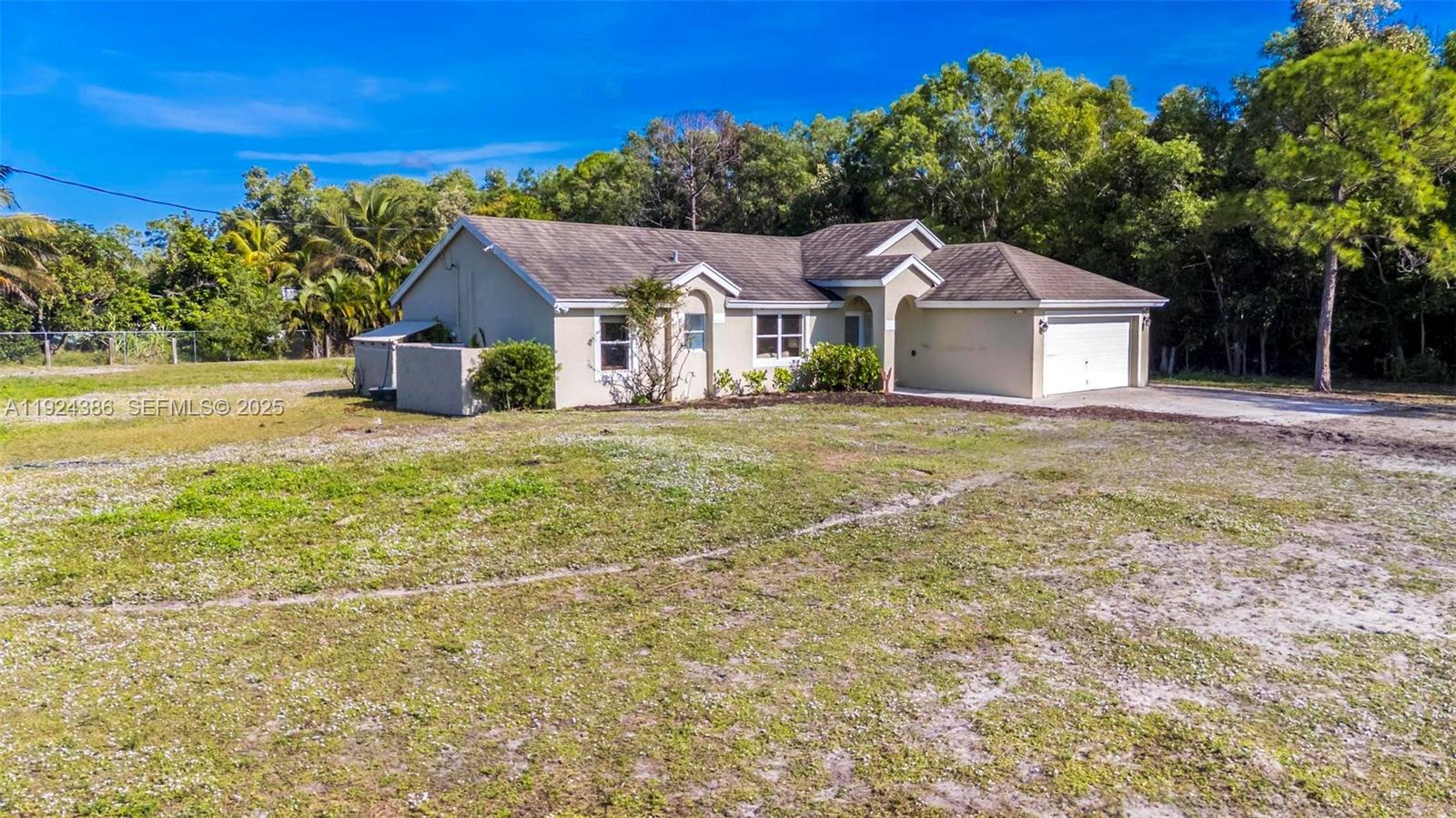 17607 88th Road North Loxahatchee, FL 33470 - Photo 33 of 56 front view of a house with a yard