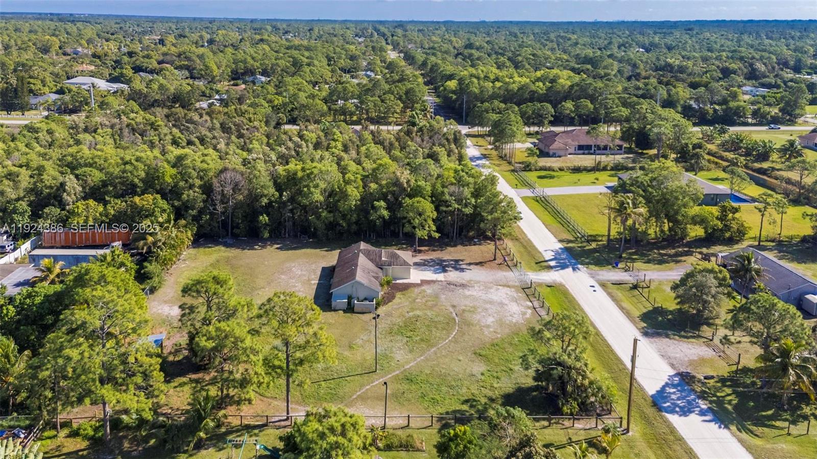 17607 88th Road North Loxahatchee, FL 33470 - Photo 43 of 56 a view of a swimming pool with a yard