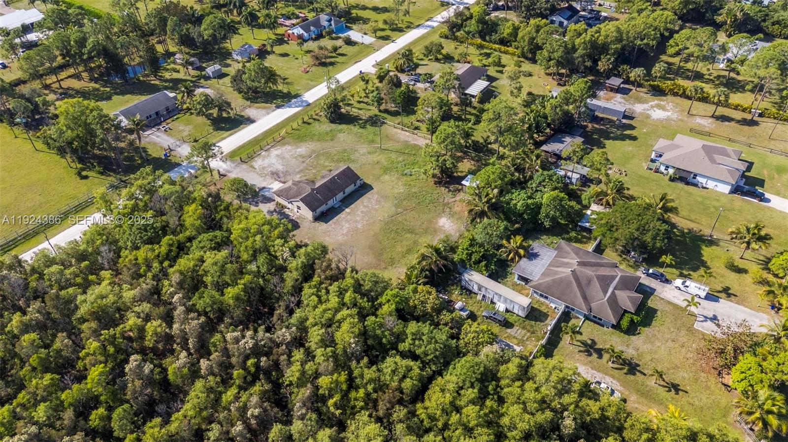 17607 88th Road North Loxahatchee, FL 33470 - Photo 48 of 56 an aerial view of residential house with outdoor space and trees all around