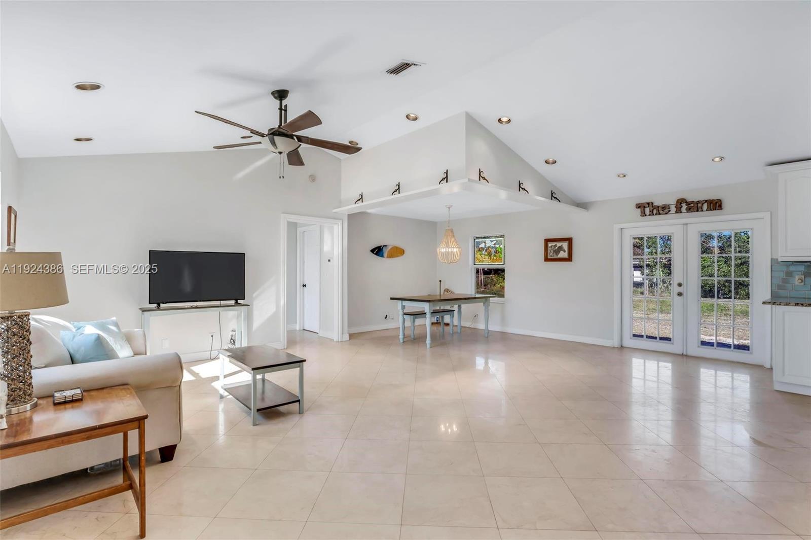 17607 88th Road North Loxahatchee, FL 33470 - Photo 9 of 56 a living room with furniture and a flat screen tv