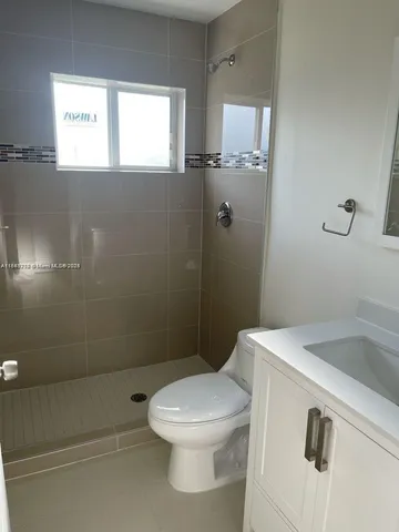 a bathroom with a toilet sink and window