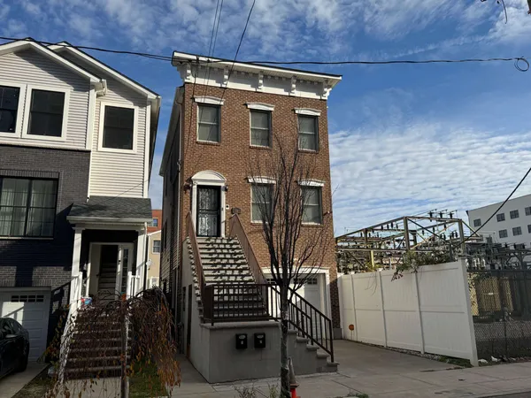 a front view of a house with stairs