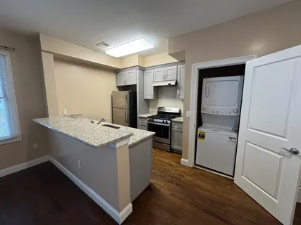 a kitchen with a sink stove and refrigerator