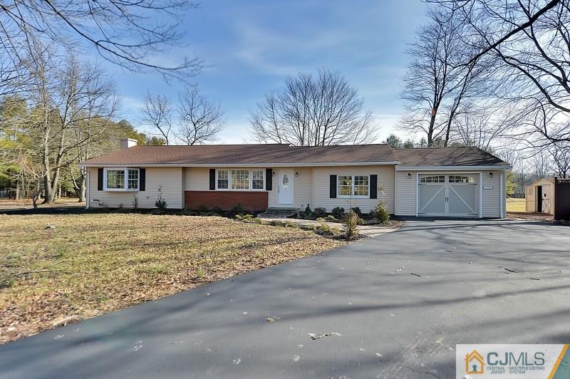 133 Allens Corner Road Flemington, NJ 08822 - Photo 2 of 13 a front view of a house with a yard and garage