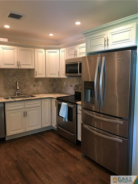 133 Allens Corner Road Flemington, NJ 08822 - Photo 4 of 13 a kitchen with granite countertop stainless steel appliances and wooden cabinets