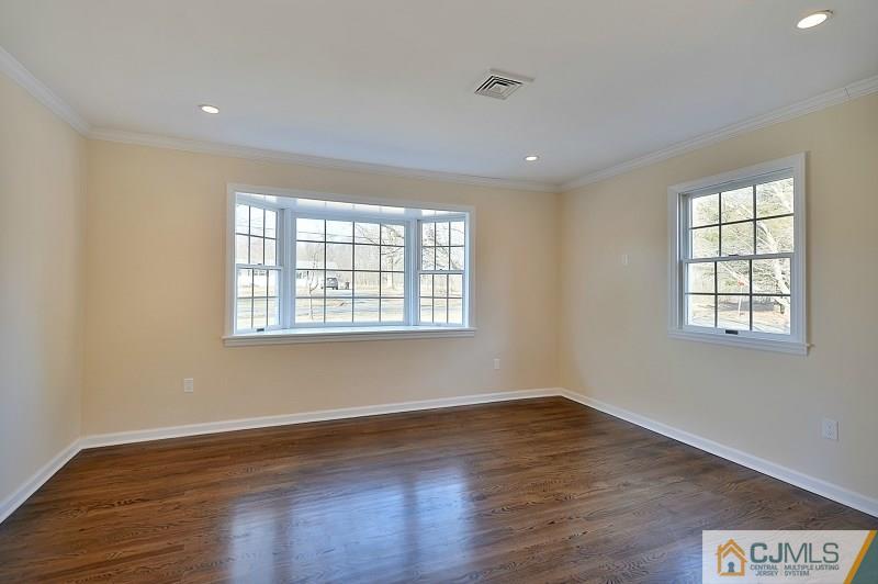 133 Allens Corner Road Flemington, NJ 08822 - Photo 5 of 13 a view of an empty room with wooden floor and a window