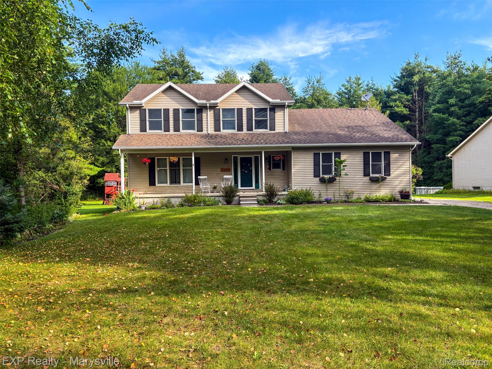 5538 Klettner Road St. Clair, MI 48079 - Photo 1 of 46 Two-story residence featuring light-colored siding, a covered front porch, and dark window shutters