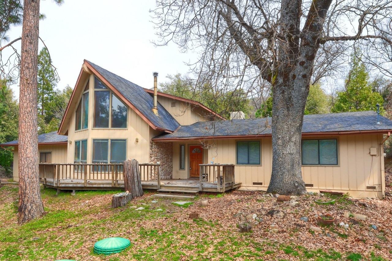 51973 Montgomery Drive Oakhurst, CA 93644 - Photo 1 of 50 a front view of a house with garden