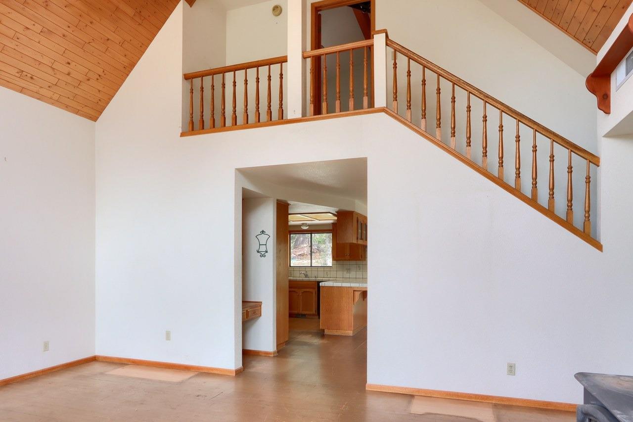 51973 Montgomery Drive Oakhurst, CA 93644 - Photo 13 of 50 a view of an entryway with wooden floor leading to a furnished livingroom and windows