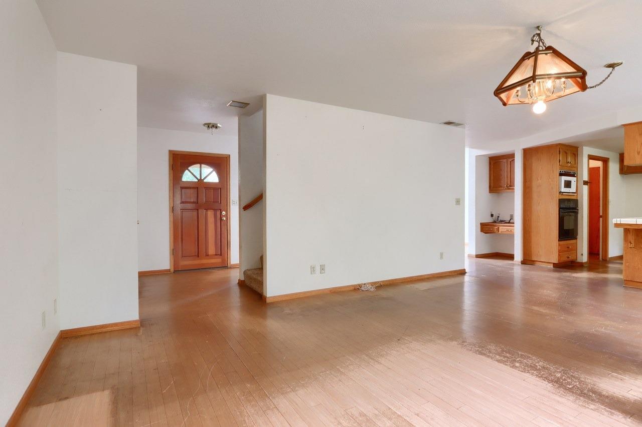 51973 Montgomery Drive Oakhurst, CA 93644 - Photo 17 of 50 a view of an empty room with window and wooden floor