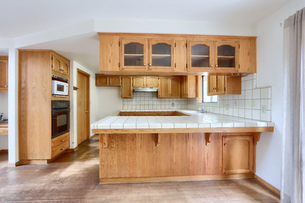 51973 Montgomery Drive Oakhurst, CA 93644 - Photo 18 of 50 a kitchen with a stove and a kitchen island