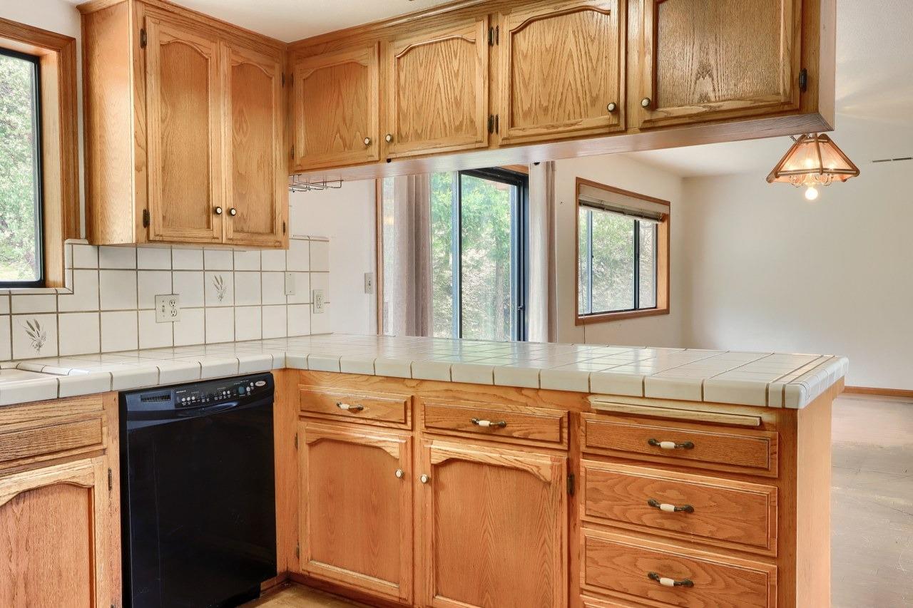 51973 Montgomery Drive Oakhurst, CA 93644 - Photo 19 of 50 a kitchen with granite countertop cabinets stainless steel appliances and a sink