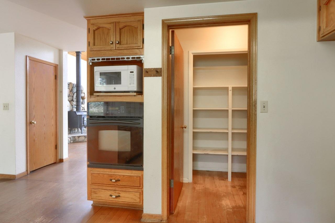 51973 Montgomery Drive Oakhurst, CA 93644 - Photo 22 of 50 a kitchen with white cabinets and a refrigerator