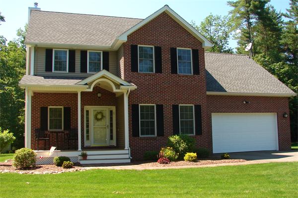 a front view of a house with a yard