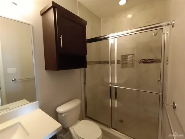 a bathroom with a toilet and a shower