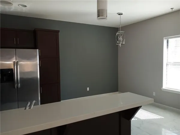 a kitchen with a refrigerator and countertop