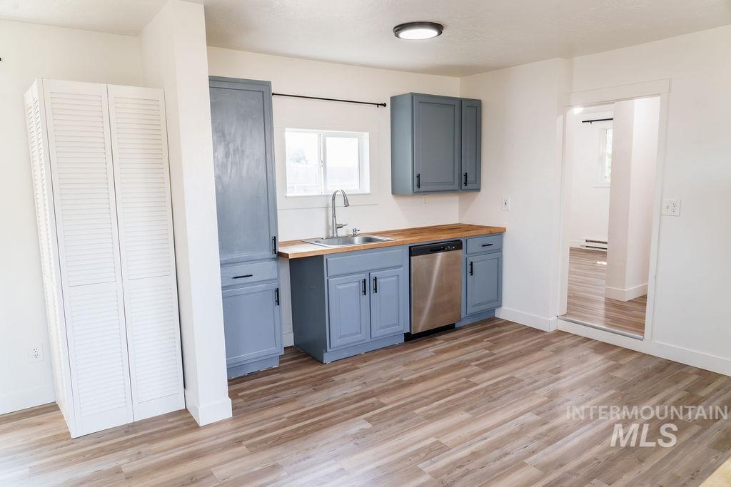 933 South Mill Road Emmett, ID 83617 - Photo 7 of 19 Modern kitchen space featuring gray cabinetry, wood-finish countertops, and stainless steel dishwasher